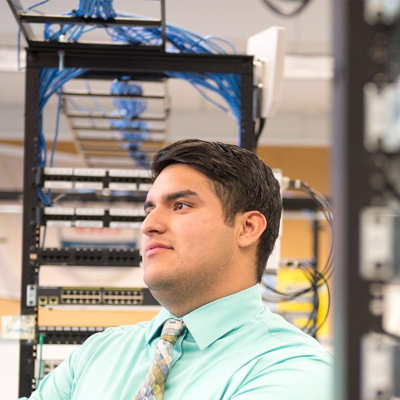 Male student posing with servers